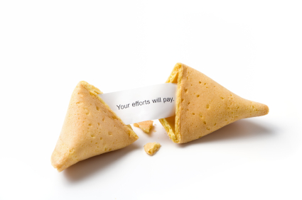 a broken fortune cookie isolated on white with message 