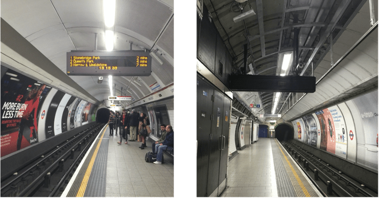 A subway station with a train on a steel track

Description automatically generated